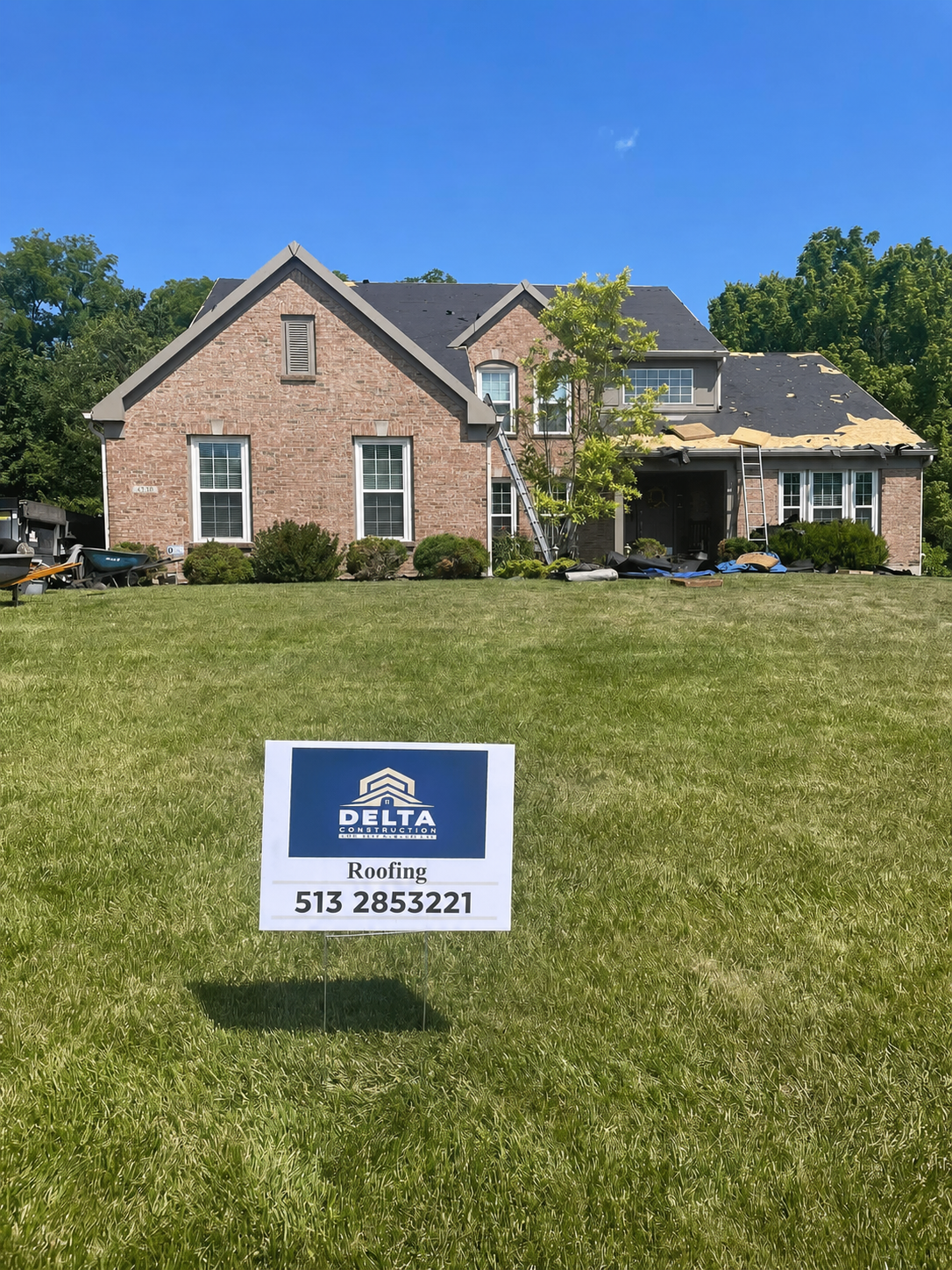 Delta Construction roofing project with company yard sign in front of home